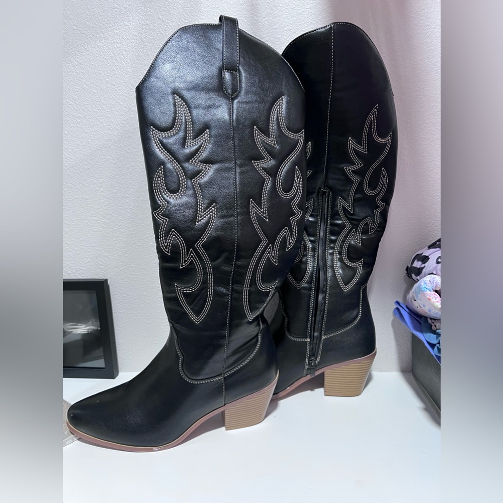 Knee high black boots with brown stitching